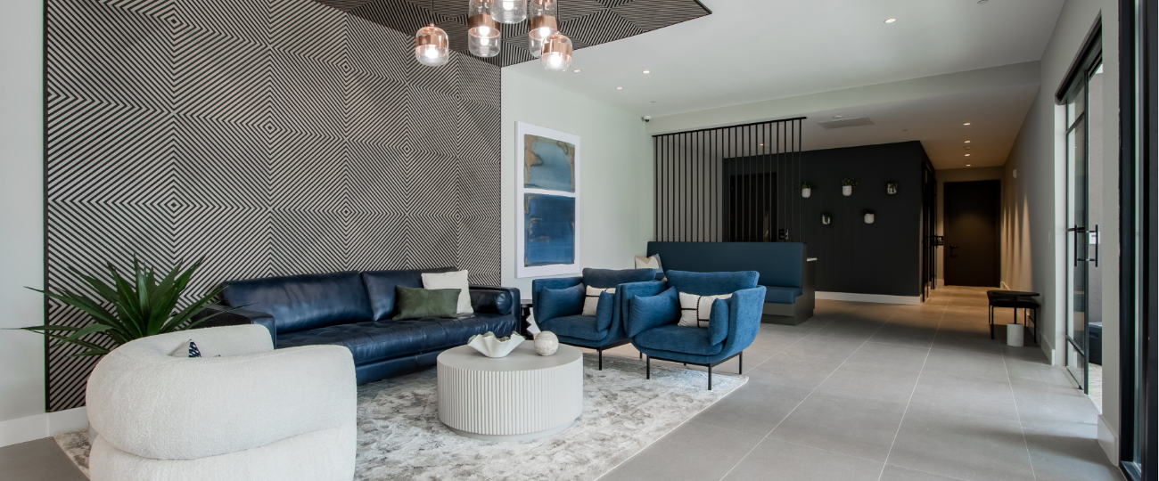 Contemporary lobby at The Rail at Bound Brook with designer furniture, statement lighting, and textured accent wall – upscale apartment living in Bound Brook, NJ.